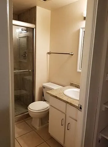 The second bathroom, which is in the hallway with doors to both of the bedrooms.