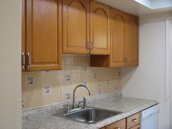 Kitchen new counter top, sink with faucet and new dishwasher