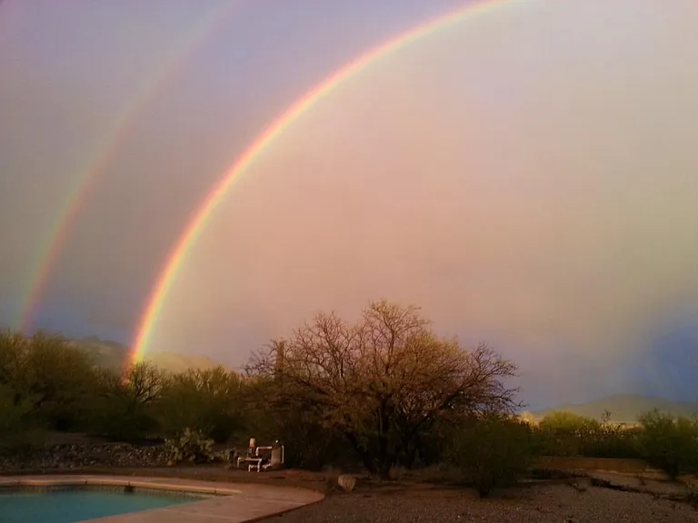Full double rainbows over pool