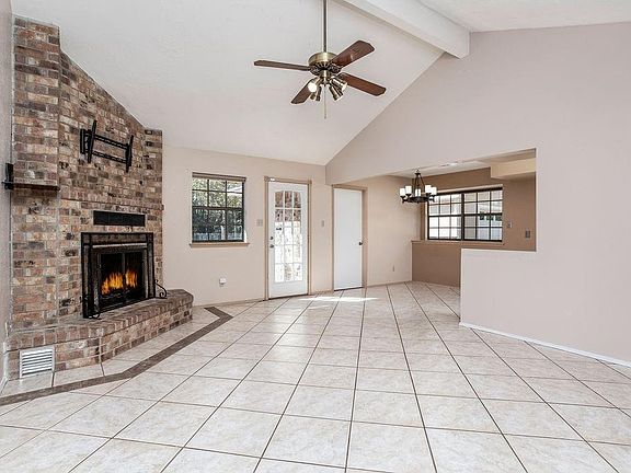 Den area with vaulted ceilings, beautiful brick heatilator fireplace and all tiled den and kitchen.