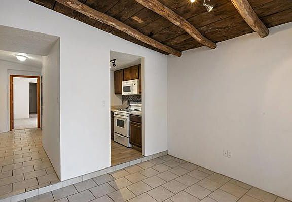 Living area with exposed viga ceiling.