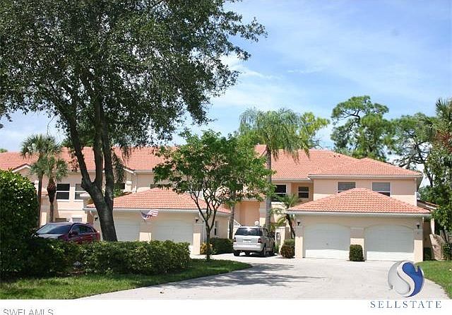 Emerald Greens Courtyard Carriage Homes with new tile roofs and beautifully maintained grounds with mature trees and tropical foliage with low maintanence