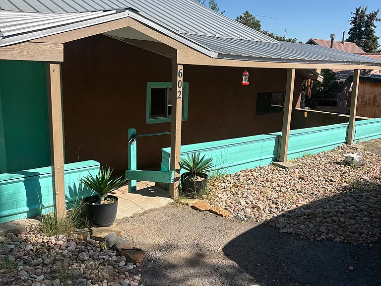 Beautifully painted front of ranch home / ideal for sitting and flower display