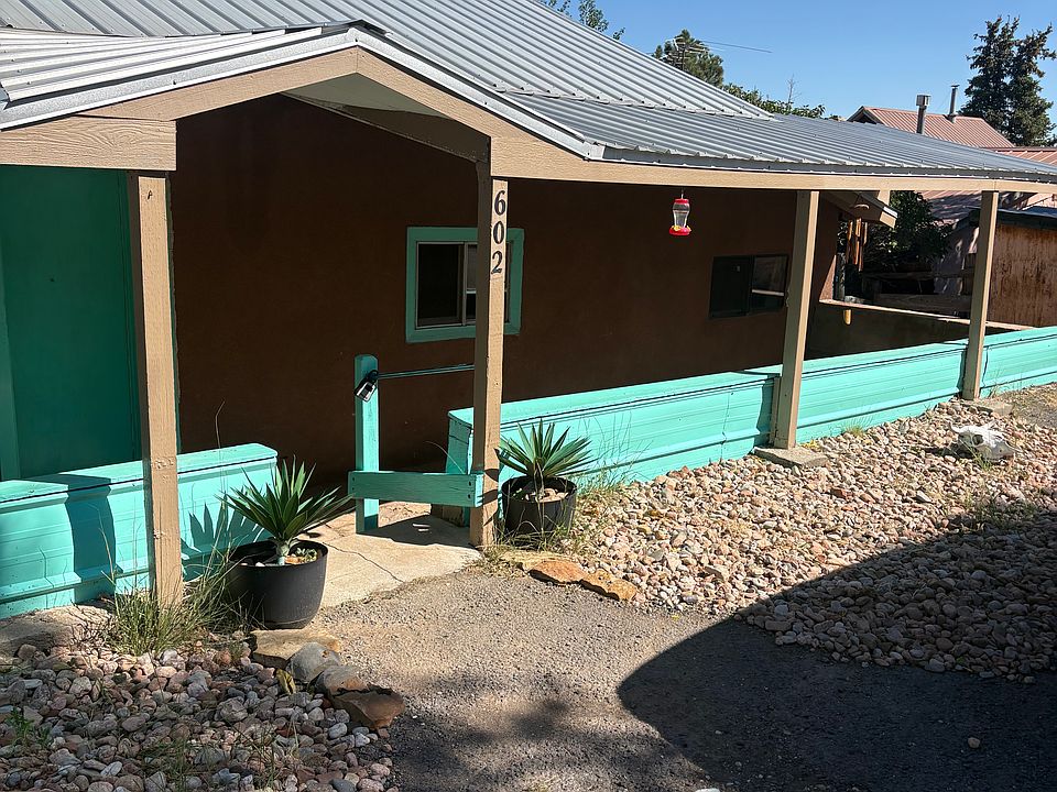 Beautifully painted front of ranch home / ideal for sitting and flower display