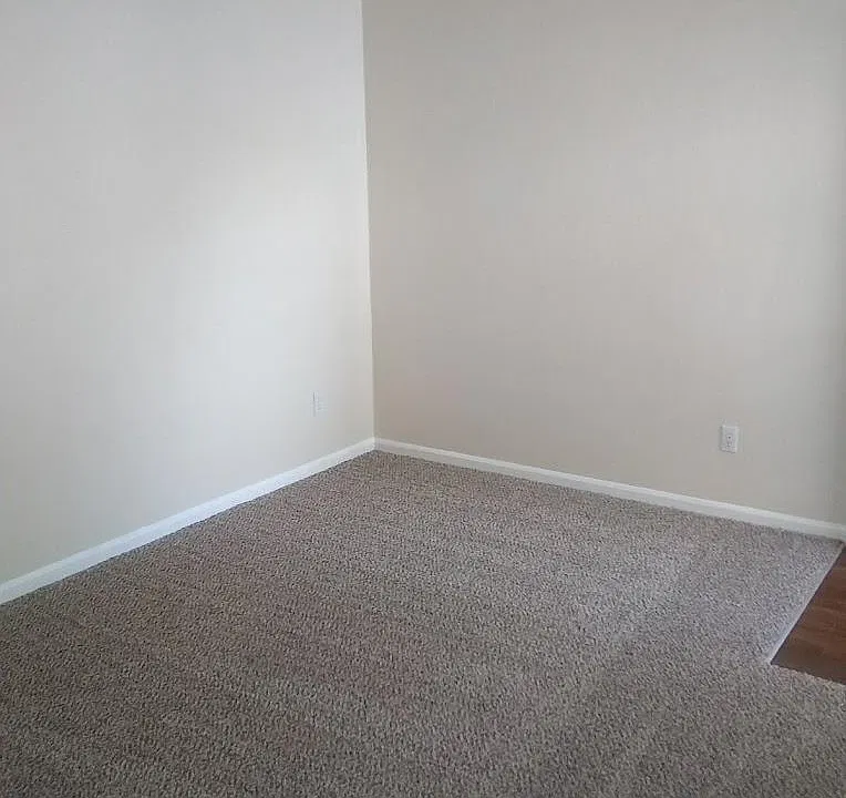 Large living room, extra thick new carpet and pad.