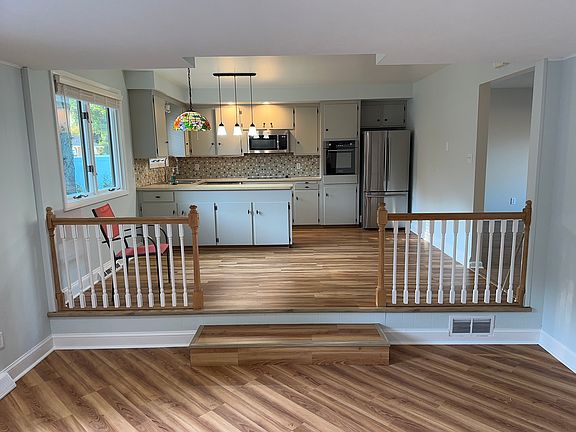 Kitchen off of family room with fireplace.
