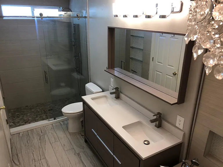 Over-sized shower with Rain showerhead, body jets and a wand. See glass shelving in mirror.