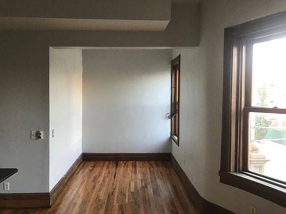 The side of the kitchen/living room is a den space, perfect for a couch and TV (wall) or office space area