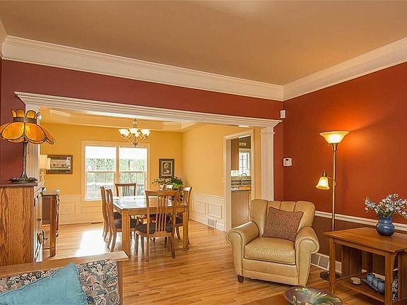 Nine inch crown moldings in the living room with dining room entrance framed in fluted pilasters.  Coordinated colors throughout; from dramatic to muted!