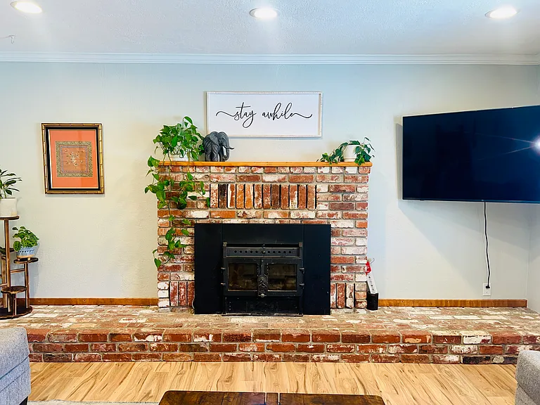 Working wood-burning woodstove with beautiful brick hearth