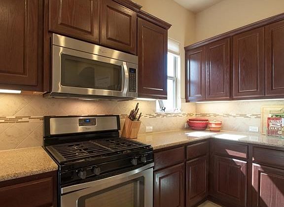 The cabinets, counters and back splash harmoniously combine to create a pleasing palette.