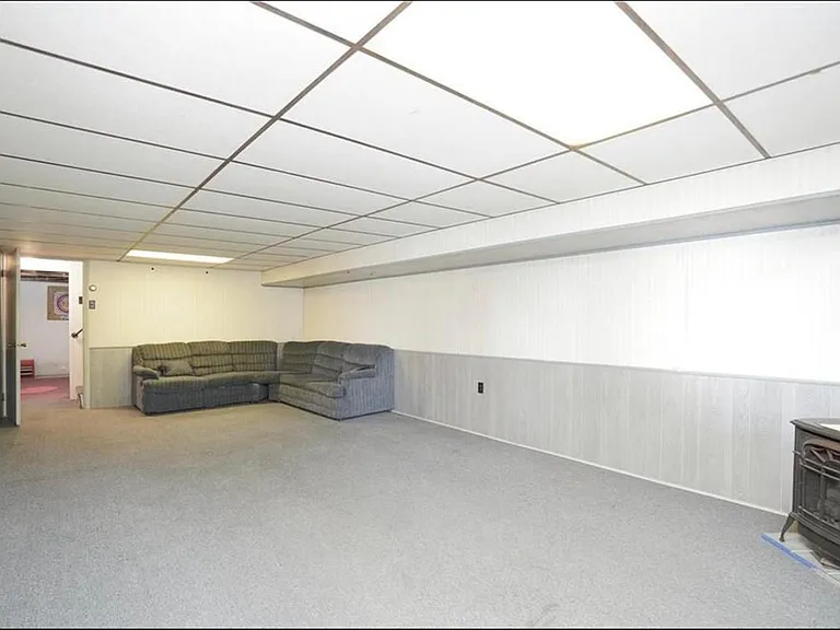 Massive is what I call this family room_ but you could call it a second master bedroom or an office. With a separate entrance and its own full bathroom, a propane cast iron stove, and access to the yard, this room has it all!
