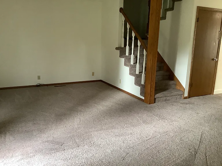 Great room is oversized and stairs up to two more bedrooms. Door leads to full unfinished basement with lots of room for storage