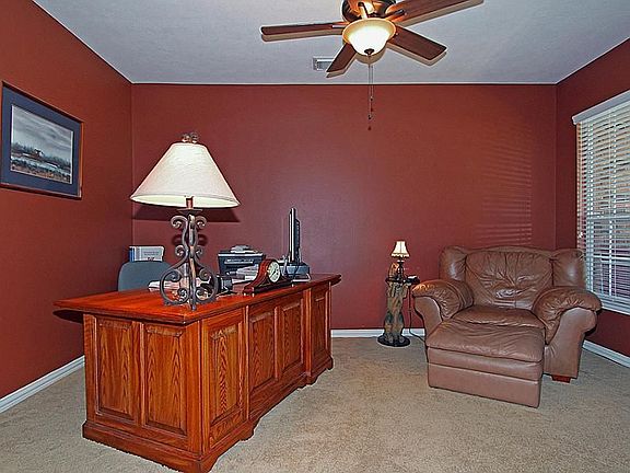 This spacious office has enough room for a full size desk and sitting area