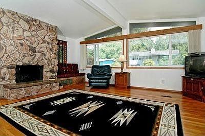 Large livingroom with hardwood floors and stone fireplace