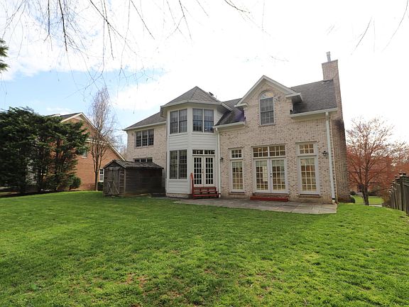 Level backyard with slate patio and garden shed. Shady and cool in the afternoons.