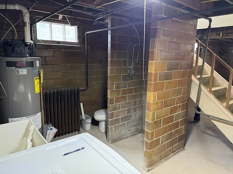 Toilet, shower and sink in basement