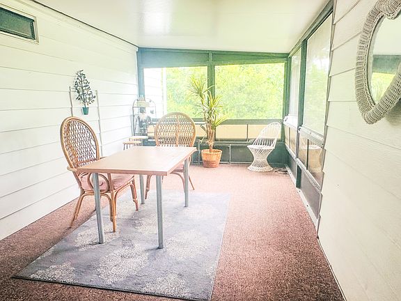 Walk in to an enclosed screened porch.