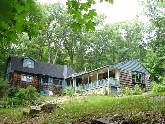 House on rise overlooking pond