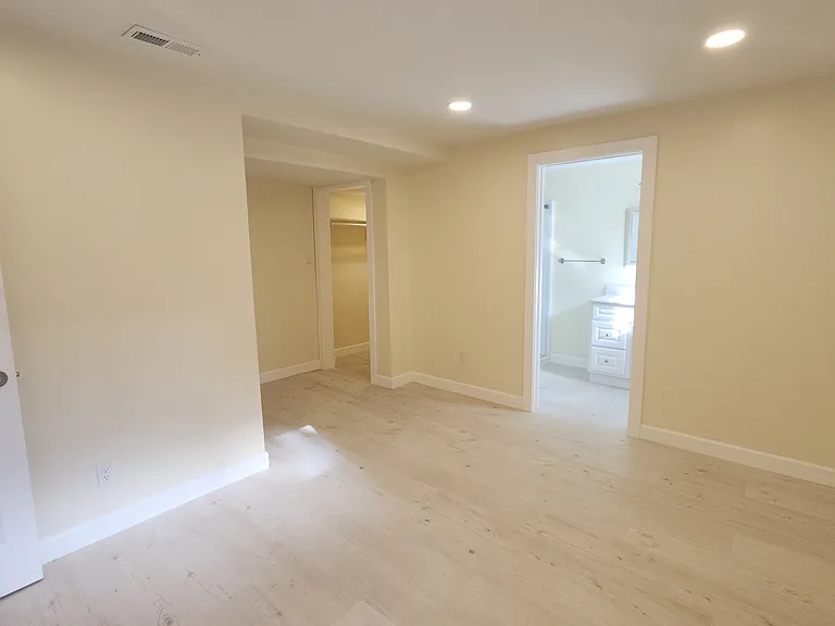 Bedroom showing entrance to bath and closet
