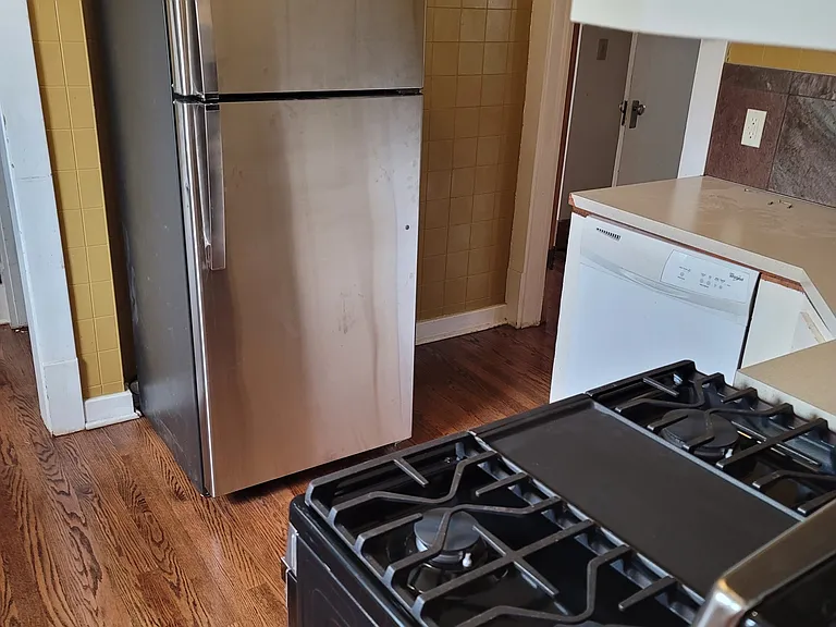 Kitchen with gas stove, stainless refrigerator