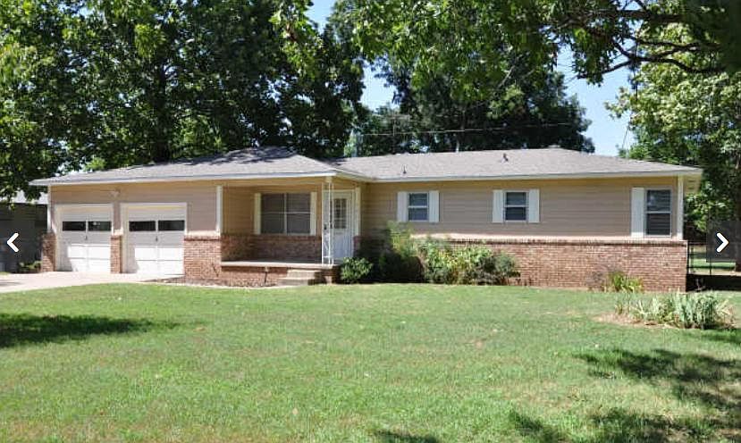 View of home from front yard -Nice Jenks School home - Two car garage - Two auto doors