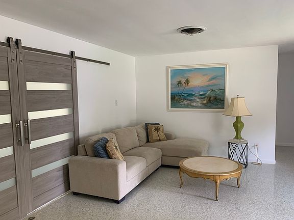 sliding doors lead to sunroom / third bedroom on back of house