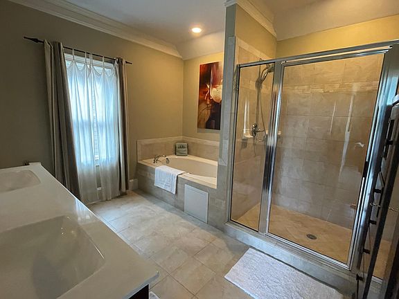 The entire top floor is the Primary Suite with King Bed, TV, exercise/reading area, piano, large walk-in closet, and enormous en suite bathroom with double vanities, Whirlpool Tub & separate dual head shower for 2!