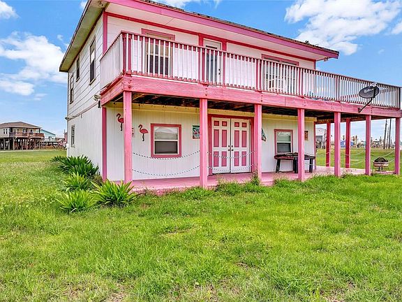 Side view of the home with double doors that open for storage of your water toys. Also, if entertaining in the party area they allow for a great ocean breeze.