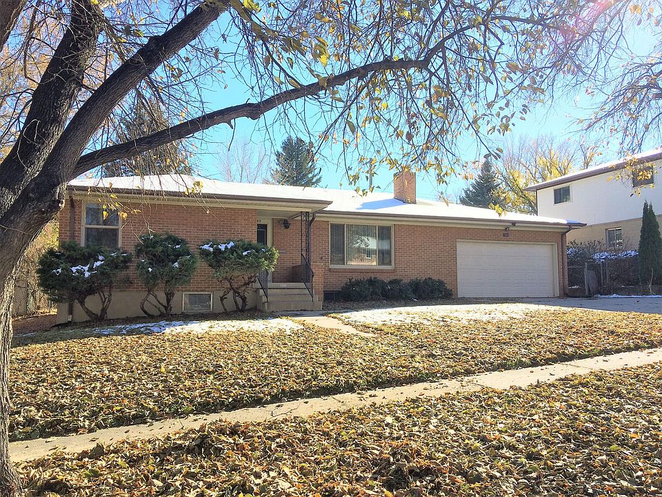 Front of home. Classic landscaping with sprinkler system, mature trees, rose bushes and a lush lawn.
