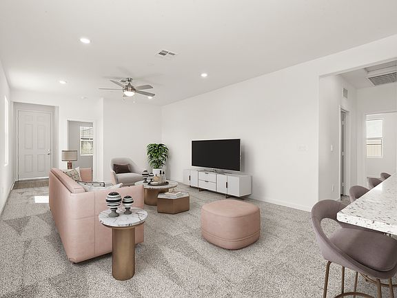 The family room is spacious with a ceiling fan.