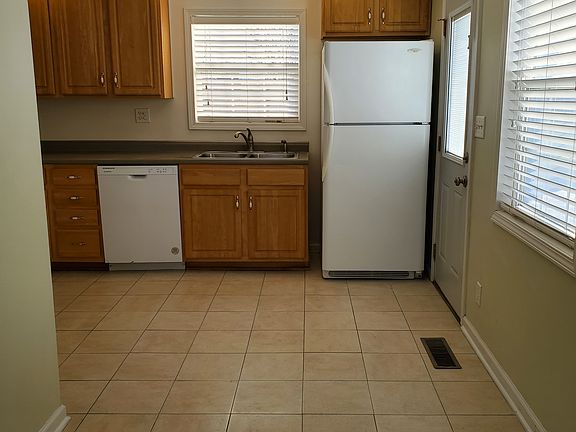 New ceramic tile kitchen floor, refrigerator, double bowl stainless steel sink, dishwasher, area for table by windos