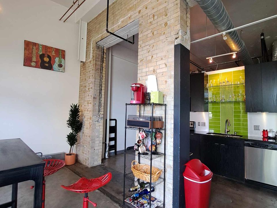 Industrial concrete flooring and brick feature walls