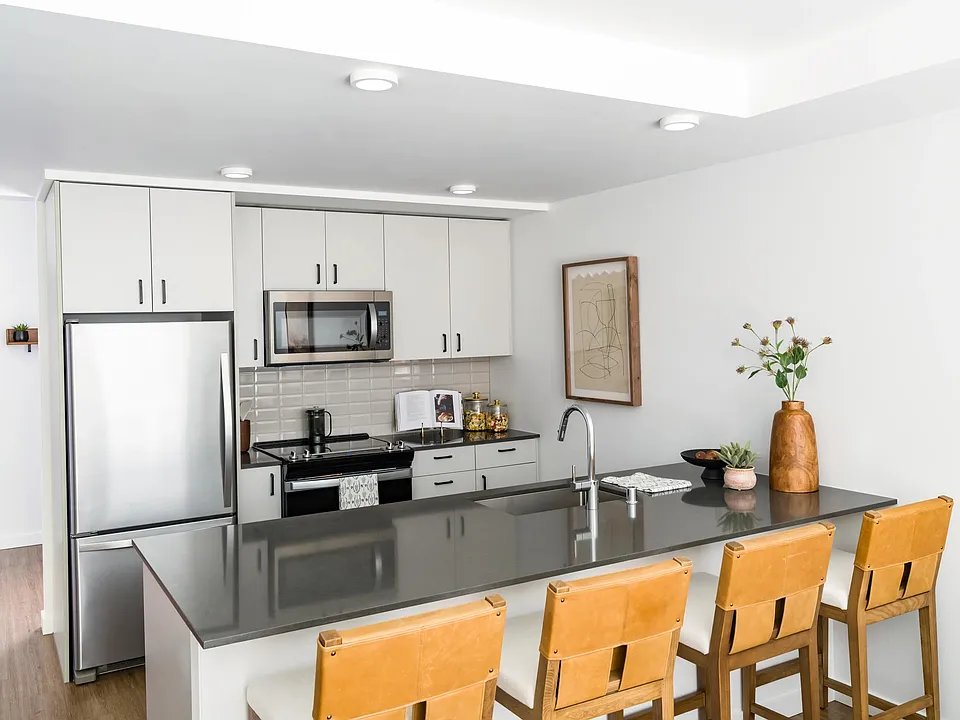Kitchen with a spacious island, stainless steel appliances, and ample seating that creates a natural hub for cooking, dining, and gathering.