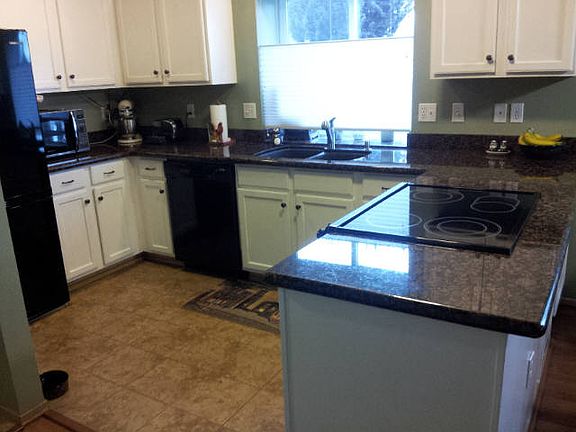 Granite counter tops, newer appliances. Stove includes a food warmer. Custom blinds.