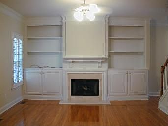 living room with built in book shelves and fireplace