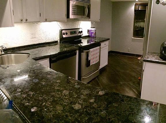 kitchen - black graniate, new stainless steel fridge, stove,