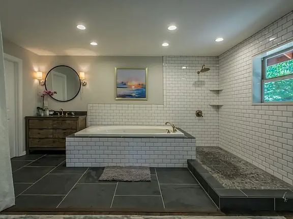 Master bathroom upstairs big soaking oversized Jacuzzi tub and outdoor shower indoors, slate floors