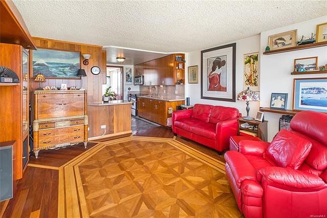 The entire unit was gutted and reconfigured and completed with custom teak flooring, and an open kitchen to living layout.