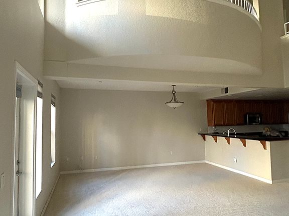 Open concept, Living/Dining room with stylish 1/2 round extending loft bedroom.