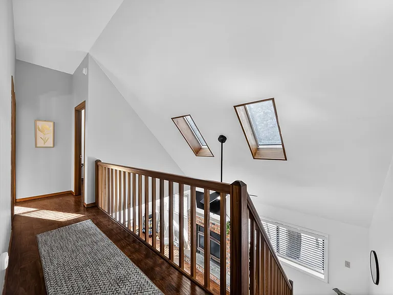 Bright Upstairs Hallway _ Open loft-style hallway with skylights that fill the space with natural light.