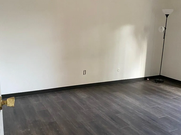 Master bedroom with sliding glass door to very mini balcony.