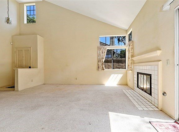 Plenty of natural light in living room with high vaulted ceiling.