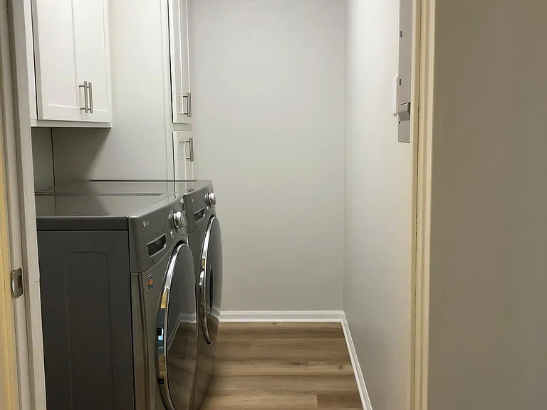 Laundry room with all new cabinetry and high end washer & dryer.