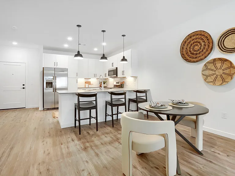 Kitchen and dining, perfectly connected. This wide-angle view of the B2 floor plan shows just how much space you get _ island bar seating, a full dining area, and an open layout that makes every square foot count.