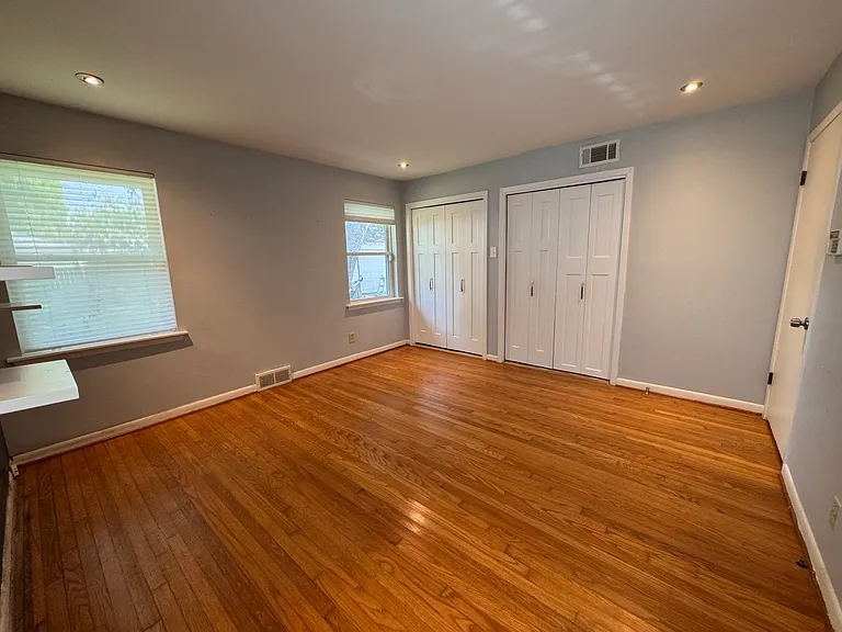 Another view of the generous primary bedroom layout, showcasing excellent natural light and abundant storage. Fresh paint is actively being applied throughout the space to ensure a pristine, turnkey move-in experience!