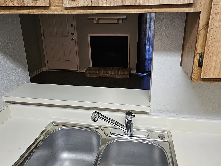 View of fireplace from the kitchen