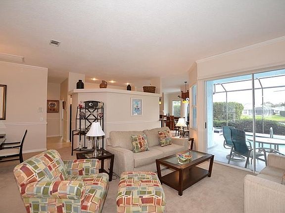 Formal living room and dining room with sliders to lanai.