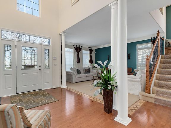 Lovely entry into the 2 Story Foyer includes Pillars and hardwood floors with decorative boarder inl