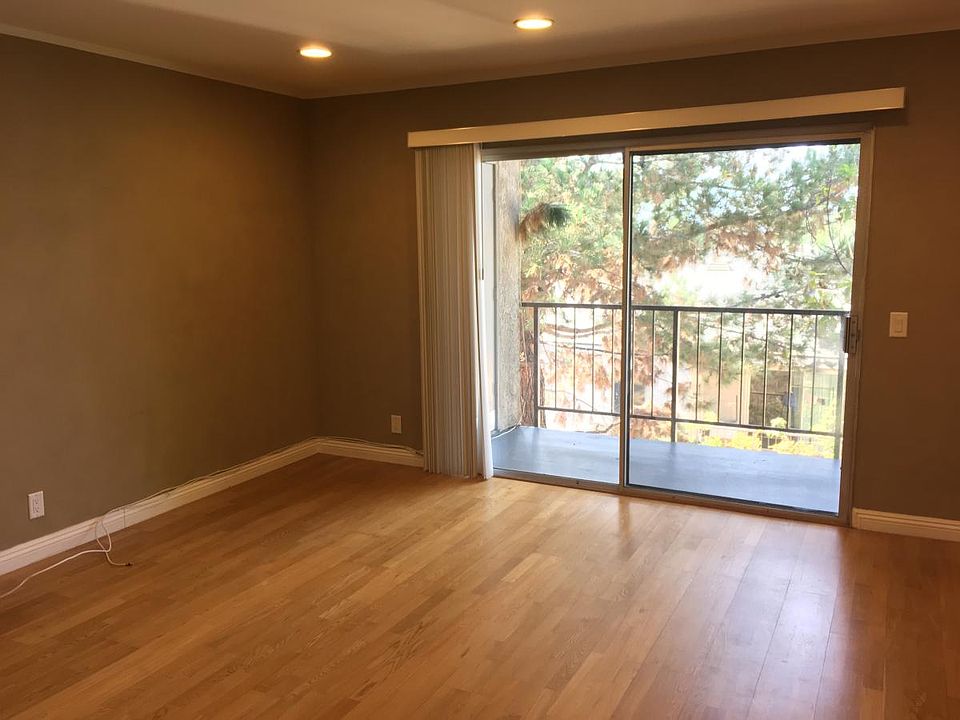 Living room with recessed lighting and hardwood floors.
